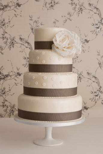 This Beautiful and Chic 4 tier Wedding Cake is made of White Vanilla Fondant
